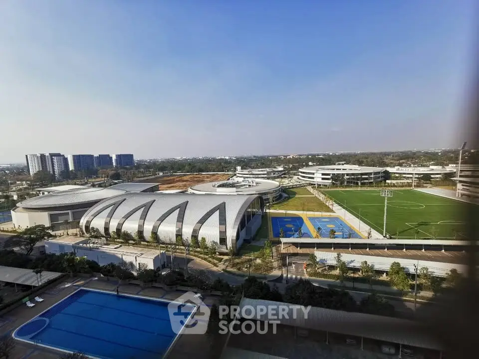 Stunning aerial view of modern sports complex with pool and fields, perfect for active lifestyle enthusiasts.