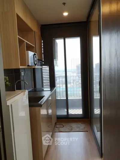 Modern kitchen with sleek design and city view from balcony