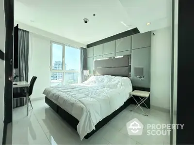 Luxurious modern bedroom with large window and stylish decor in high-rise apartment.