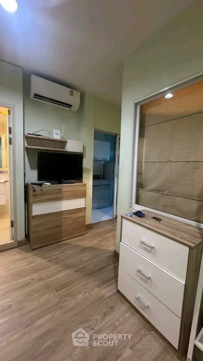 Modern apartment interior with air conditioning and stylish wooden furniture