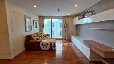 Spacious living room with modern decor and large window for natural light.