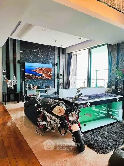 Luxurious living room with modern decor and unique motorcycle display.