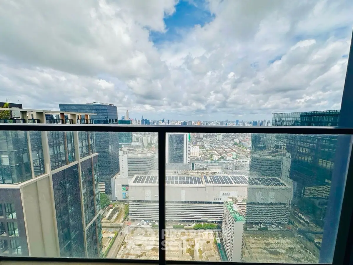 Stunning cityscape view from a high-rise balcony with expansive skyline and modern architecture.