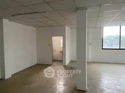 Spacious open-plan interior with natural light and tiled flooring, ideal for customization.