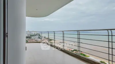Stunning beachfront balcony with panoramic ocean views and modern railing.