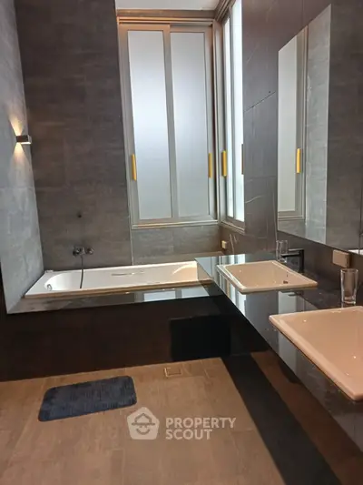 Luxurious modern bathroom with sleek design and large window for natural light.