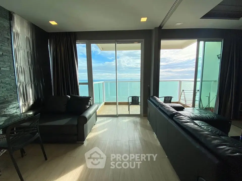 Luxurious living room with stunning ocean view and spacious balcony, perfect for relaxation and entertaining.