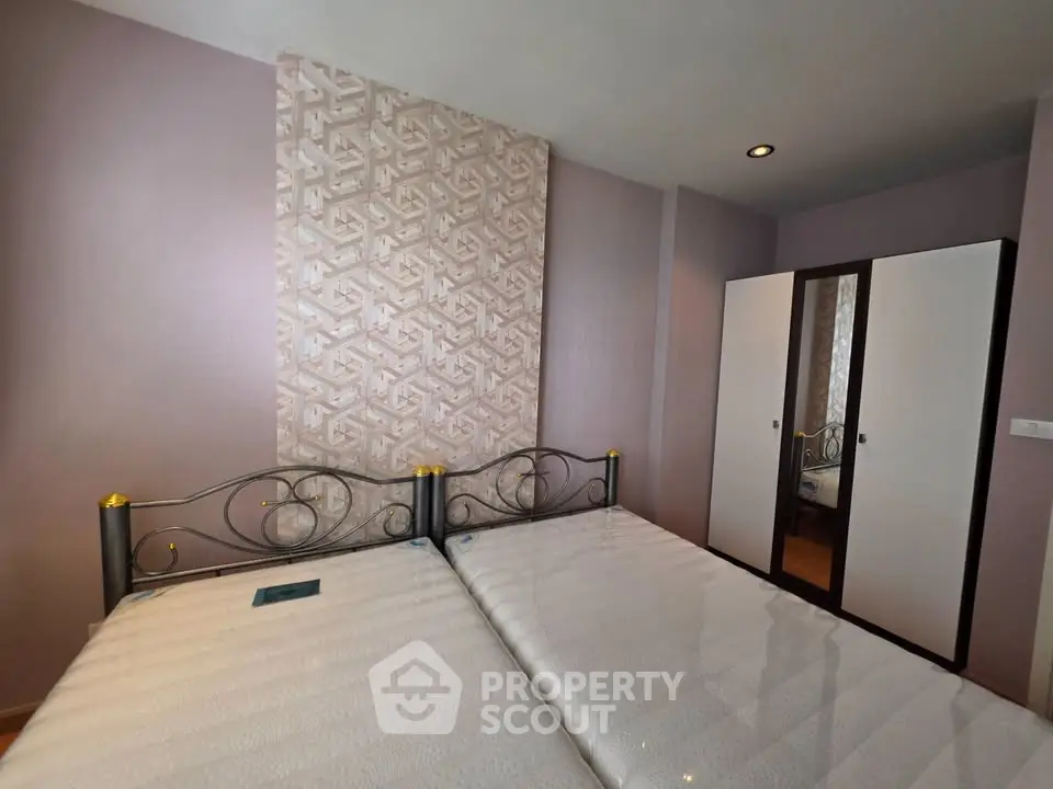 Spacious bedroom with stylish decor and ample storage in modern real estate property.