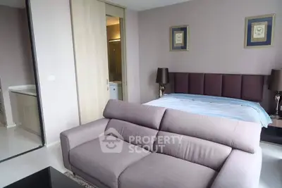 Modern bedroom with stylish decor and cozy sofa in a contemporary apartment.