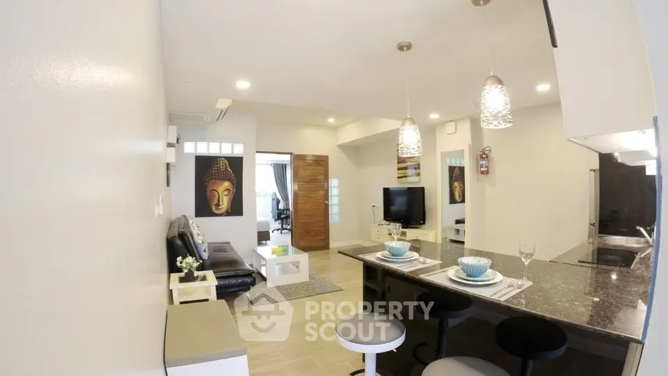 Modern open-plan living room with stylish kitchen and cozy seating area