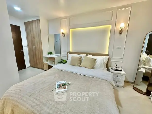 Luxurious bedroom with elegant decor and cozy ambiance, featuring a stylish bed and modern lighting.