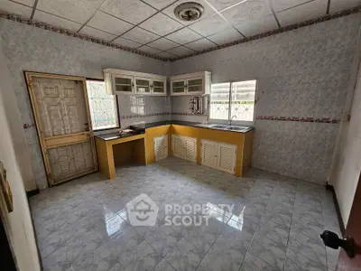 Spacious kitchen with vintage tile design and ample natural light