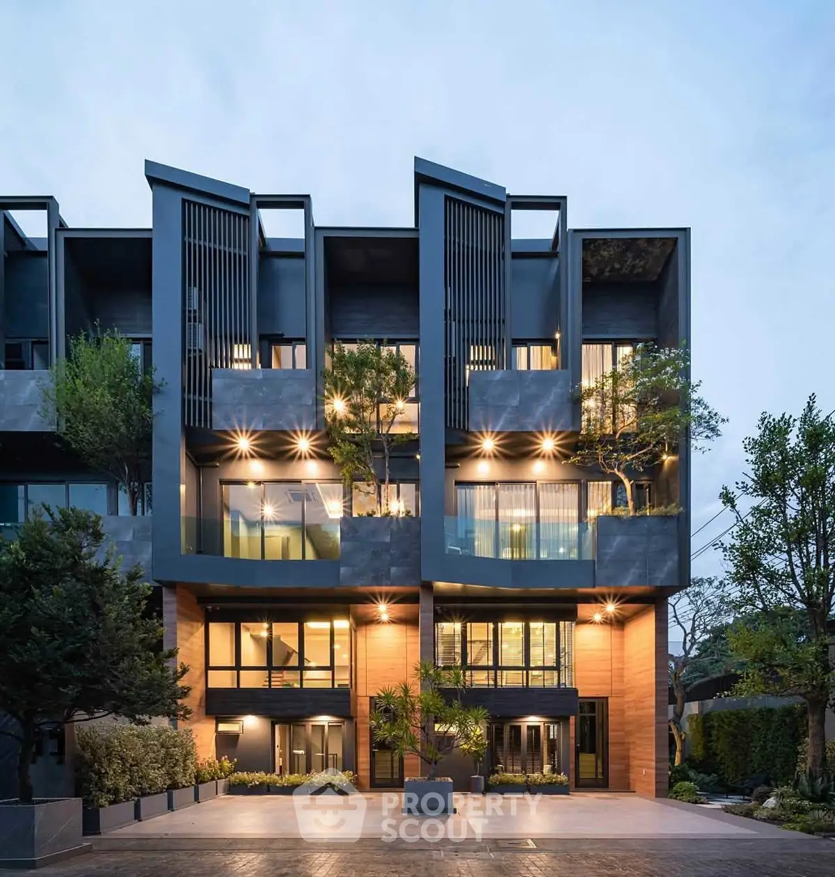 Modern architectural building with unique facade and lush greenery, showcasing contemporary urban living.