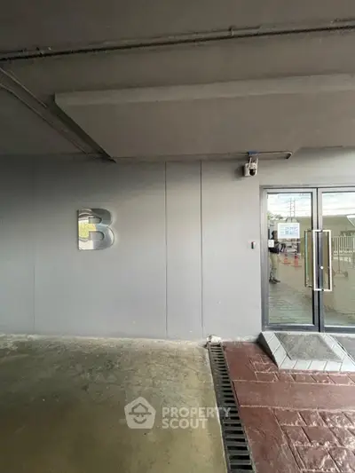Modern building entrance with sleek design and security camera