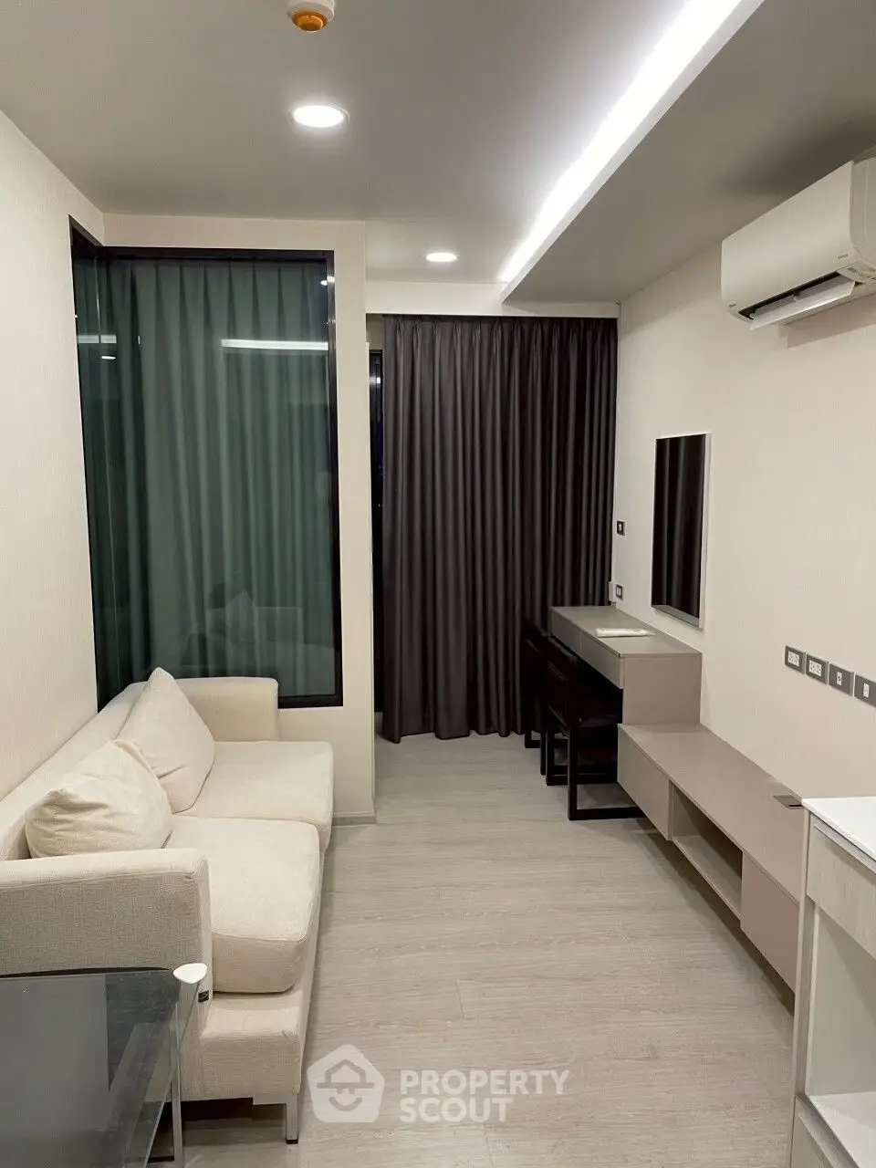 Modern living room with sleek design, featuring a cozy sofa and stylish furniture, perfect for urban living.