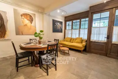 Charming living room with elegant dining area and cozy seating, perfect for relaxation.