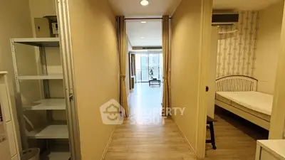 Spacious apartment hallway leading to a bright living area with modern decor.