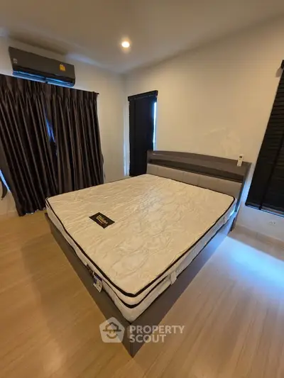 Modern bedroom with stylish bed and elegant curtains in a cozy setting.