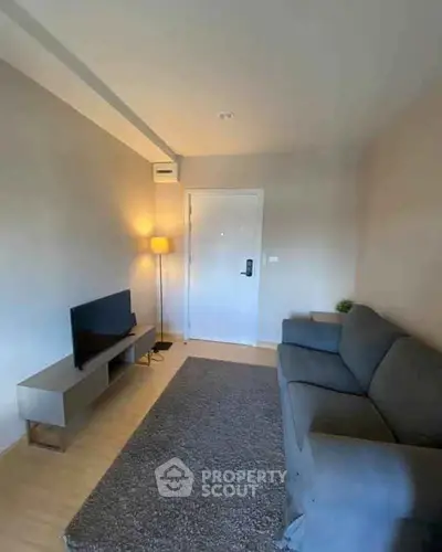 Cozy living room with modern decor and comfortable seating in a stylish apartment.
