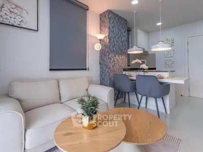 Modern living room with cozy seating and stylish dining area in open layout apartment.