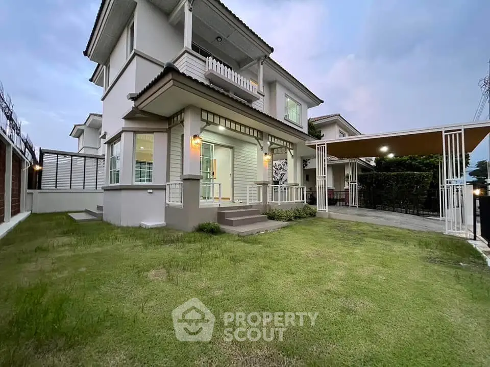 Charming two-story house with manicured lawn and covered carport in a serene neighborhood.