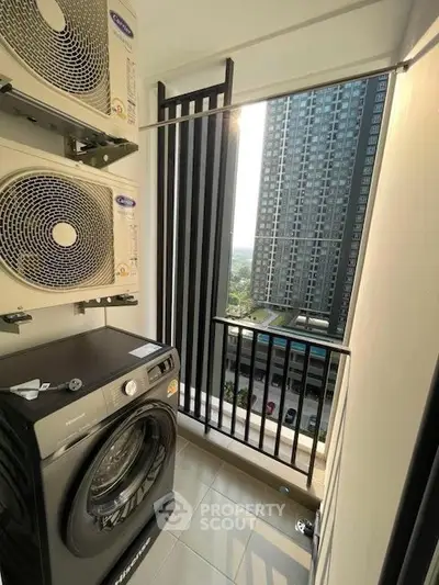 Modern apartment balcony with washing machine and city view, perfect for urban living.