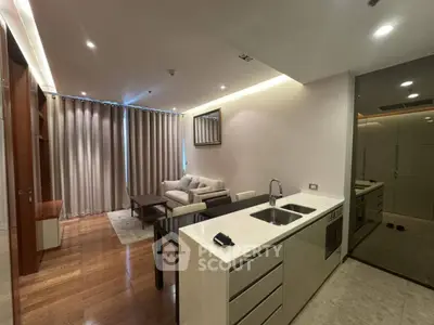 Modern open-plan living room with sleek kitchen and cozy seating area.