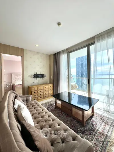 Luxurious living room with ocean view and elegant furnishings in a high-rise apartment.