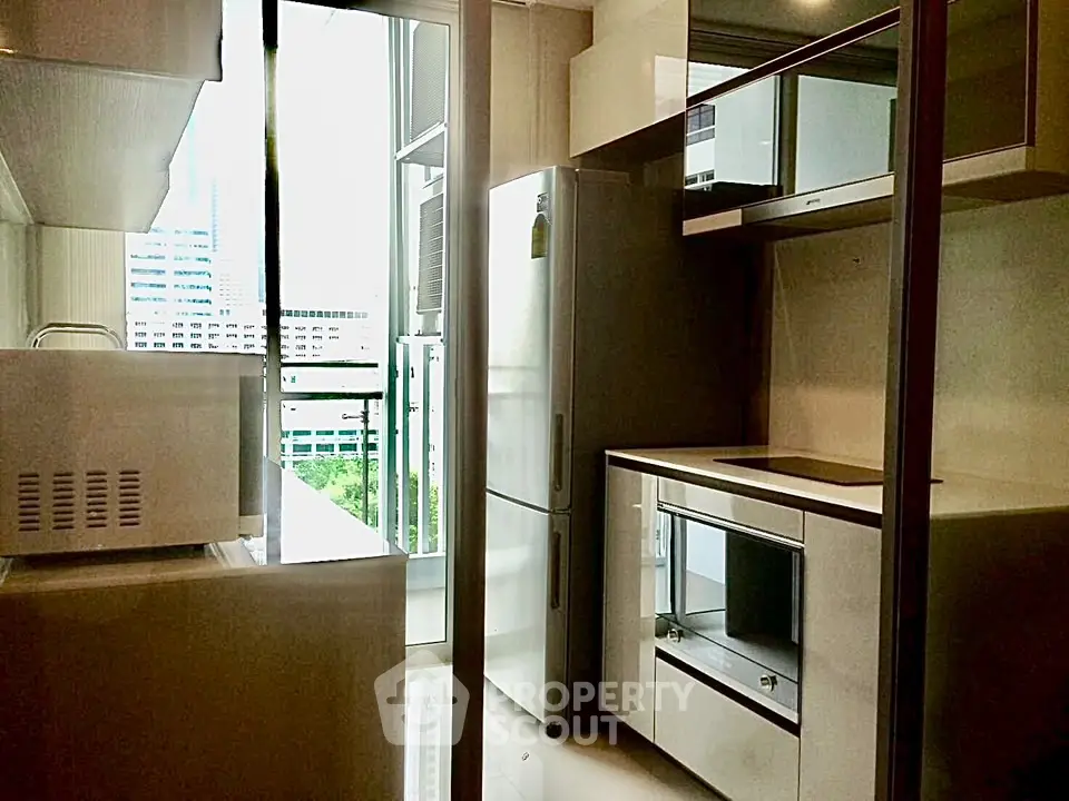 Modern kitchen with sleek appliances and city view from balcony