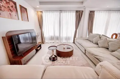 Spacious living room with elegant decor and large windows for natural light.