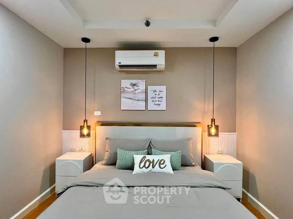 Modern bedroom with stylish decor and cozy ambiance, featuring elegant lighting and air conditioning.
