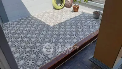 Charming tiled balcony with decorative pots and plants, perfect for relaxation.