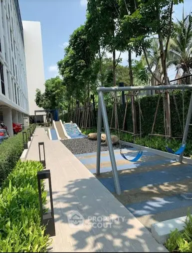 Lush green outdoor space with modern hammocks, perfect for relaxation in a serene residential environment, enhancing the living experience.