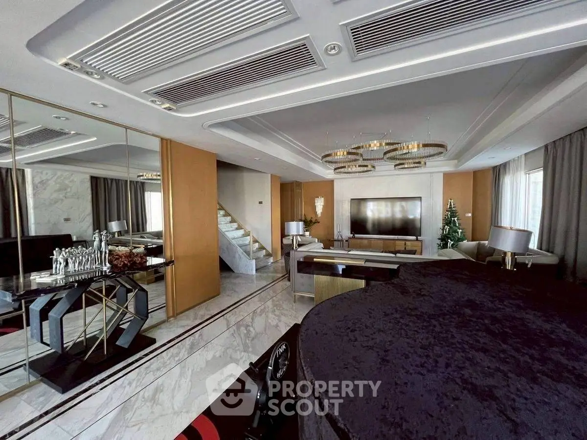 Luxurious living room with elegant decor and modern furnishings, featuring a grand piano and stylish lighting.