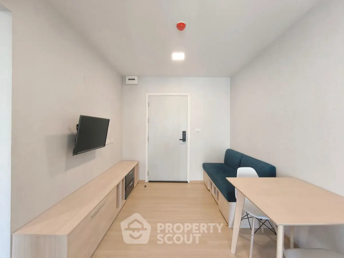 Modern minimalist living room with sleek furniture and wall-mounted TV