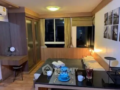 Cozy bedroom with modern decor and dining setup, perfect for urban living.