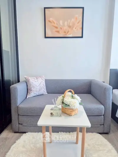 Cozy living room with modern gray sofa, stylish decor, and soft lighting for a welcoming ambiance.