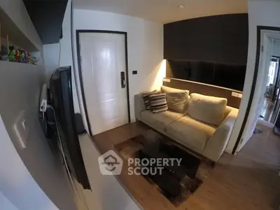 Cozy living room with modern decor and plush sofa in a stylish apartment.