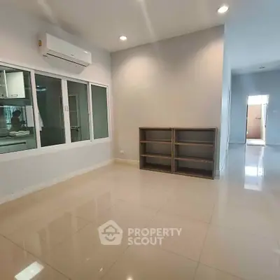 Spacious modern living room with air conditioning and sleek tile flooring