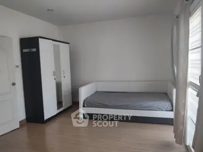 Spacious bedroom with modern furniture and natural light