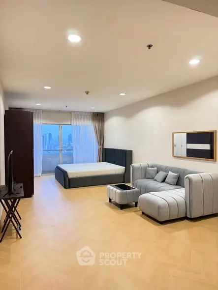 Spacious modern studio with stylish furniture and city view