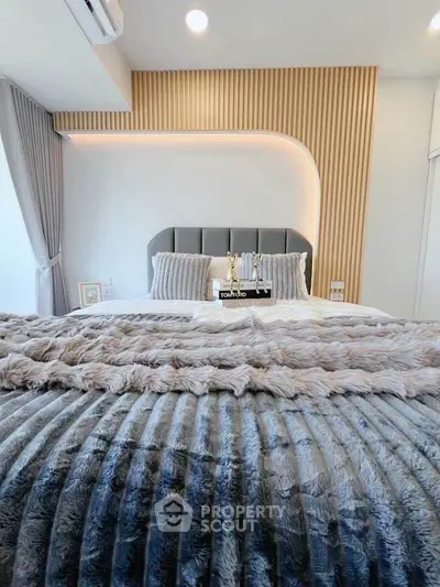 Luxurious modern bedroom with plush bedding and stylish decor