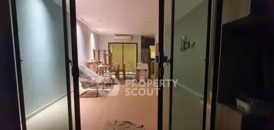 Spacious living room with modern decor and large glass doors