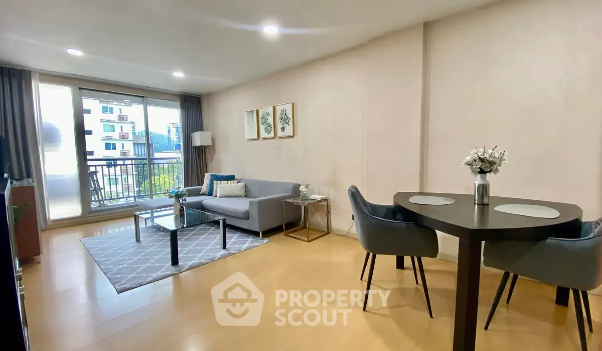 Modern living room with balcony view, stylish furniture, and elegant decor