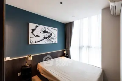 Modern bedroom with abstract art and large window, featuring elegant lighting and minimalist design.