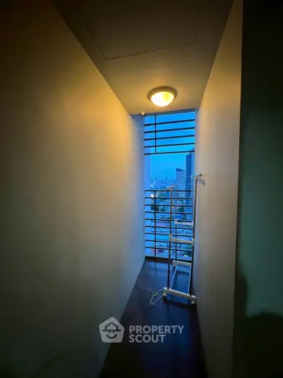 Narrow balcony with city view and minimalist design, perfect for urban living.