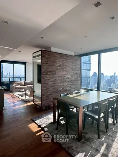Luxurious modern dining and living area with stunning city views and elegant furnishings.