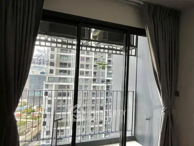 Modern apartment balcony with city view and large glass doors
