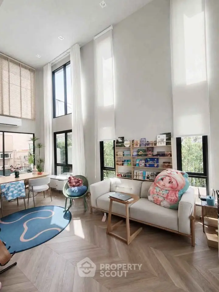 Spacious modern living room with high ceilings and large windows