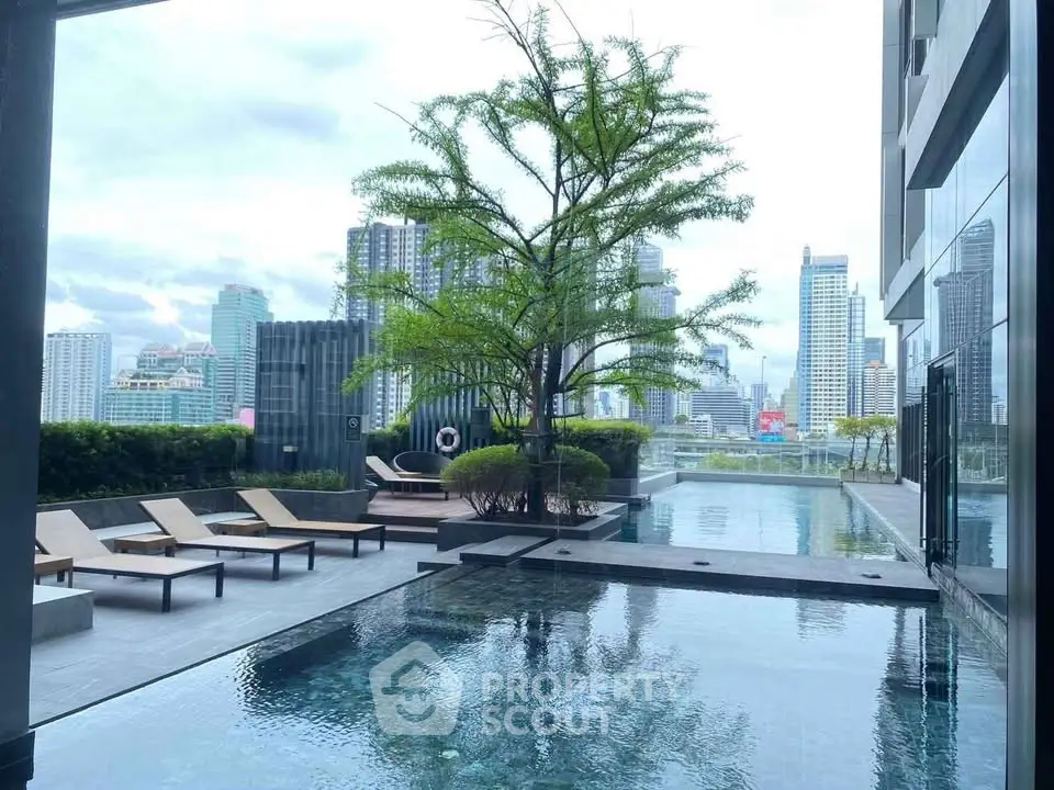 Luxurious rooftop pool with stunning city skyline views and modern lounging area.